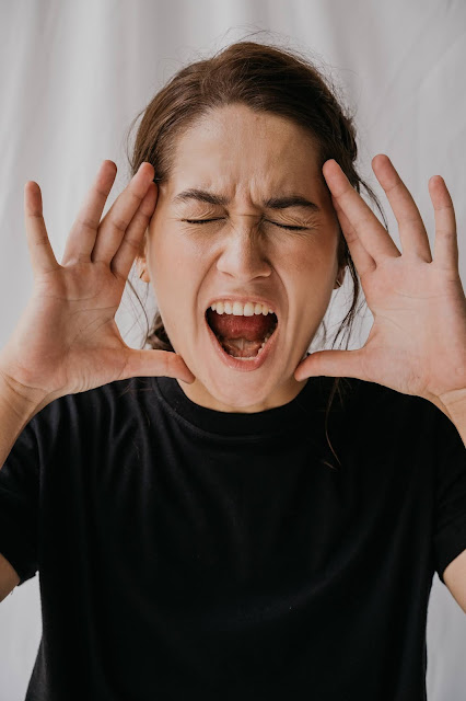 A woman criticizing others by shouting and yelling at them.