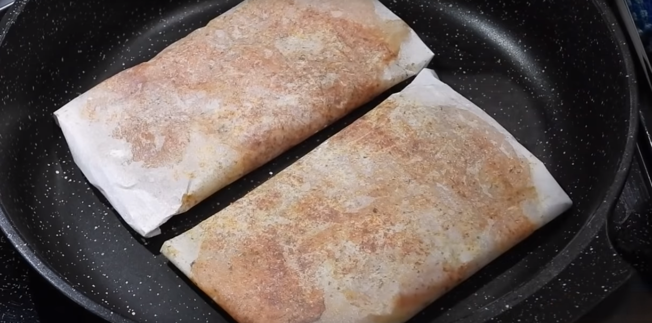 куриное филе в пергаменте на сковороде.