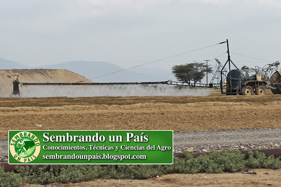 fumigación con tractor y brazo mecánico