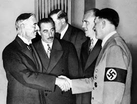Hitler shakes Neville Chamberlain's hand in Munich worldwartwo.filminspector.com
