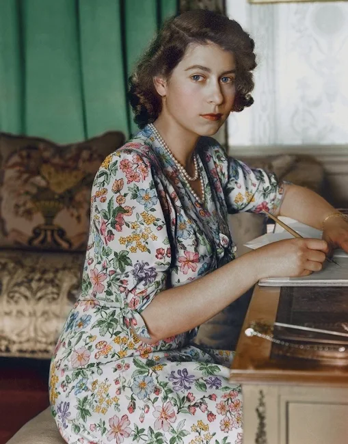 Britain's Princess Elizabeth (Queen Elizabeth II) pictured seated at a desk reading a book at Windsor Castle, Berkshire in Britain