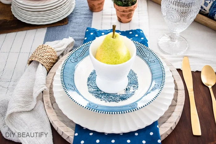 vintage dishes, gold flatware, and textured napkin holders
