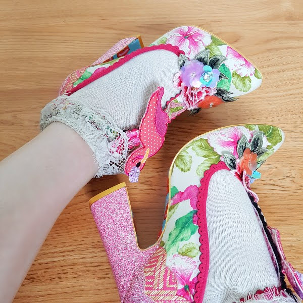 wearing pink floral shoes with flamingo detail and glitter heel