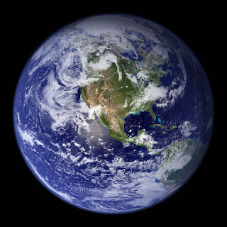 One Blue Marble by Nasa's Earth Observatory. The Blue, white and green Earth against a black sky.