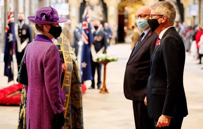 Princess Anne wore an eye-catching purple coat and matching hat, a pale lilac scarf and black knee-high boots