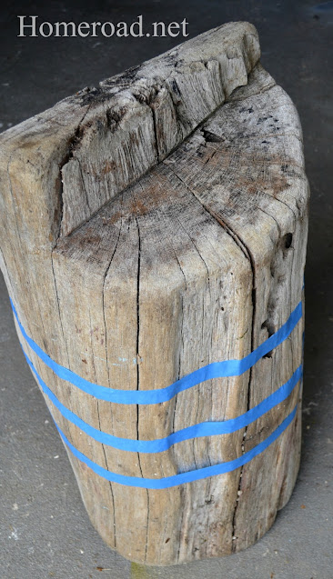 wooden stump with painter's tape stripes
