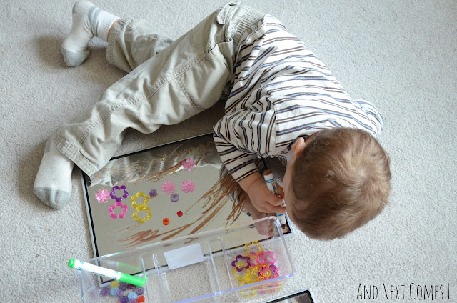 Child doodling on a mirror as part of spring drawing activity