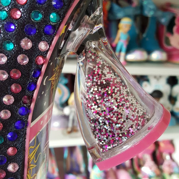 close up of hourglass shaped transparent heel with loose glitter inside