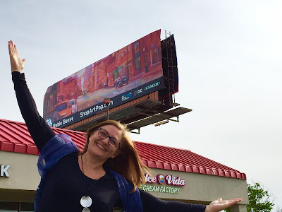 Robie Benve in front of her Billboard in Columbus Photo of Robie with Billboard