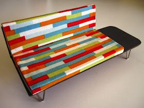 Mid century modern miniature sofa with attached coffee table.
