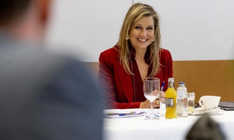 Queen Maxima wore a floral brocade long coat from Oscar de la Renta, and red LaPerm blazer, Lykoi trousers and Korat red blouse from Claes Iversen