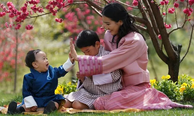 King Jigme Khesar Namgyel Wangchuck, Queen Jetsun Pema, Gyalsey Jigme Namgyel and Gyalsey Ugyen. Satin dress