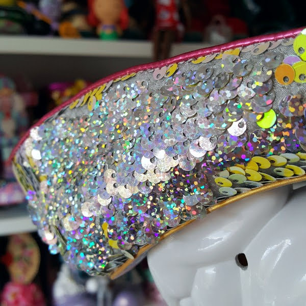 close up of flip side of sequins uppers on shoes in silver holographic finish