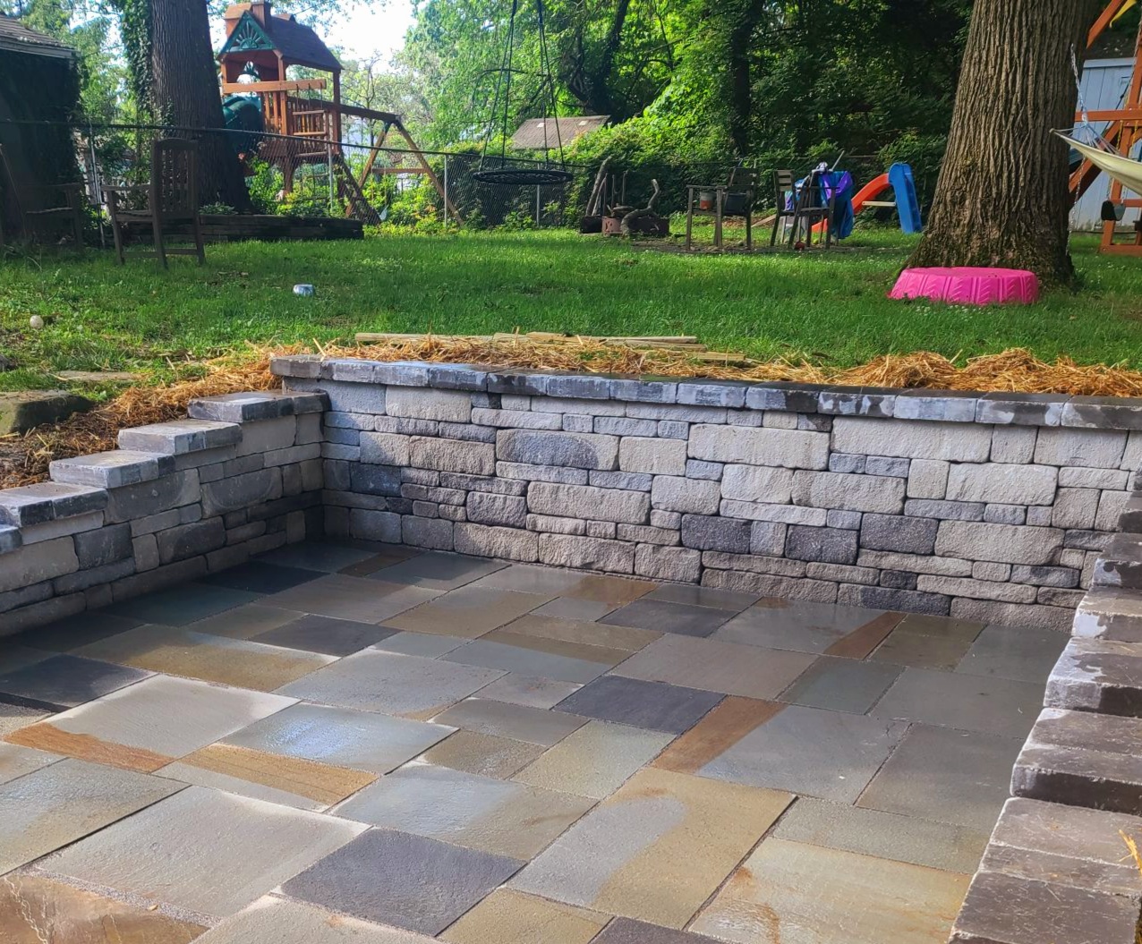 Custom Stoneworks & Design Inc. Flagstone Patio with Retaining Wall