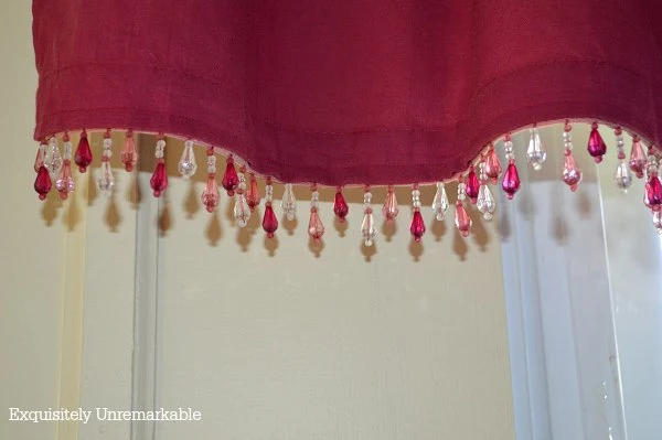 Red valances with beads added for interest