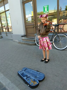 Young child Street musician in Riga Old Town..
