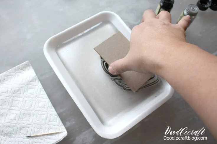 Supplies needed for Easy Marble marbling.  Styrofoam shallow dish with 1/4 inch of water.  Easy Marble in black and white.  White card stationery.  Toothpick, gloves, paper towels, acetone.