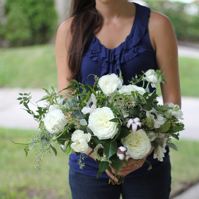 The Brides bouquet was an asymetrical wild organically textured wandering hand tied collection of ranunculus, jasmine, seeded eucalyptus, cotton, camellia, anemone, and alabaster garden roses. sweet pea floral design ann arbor detroit holly rutt misty farms fruitig farms