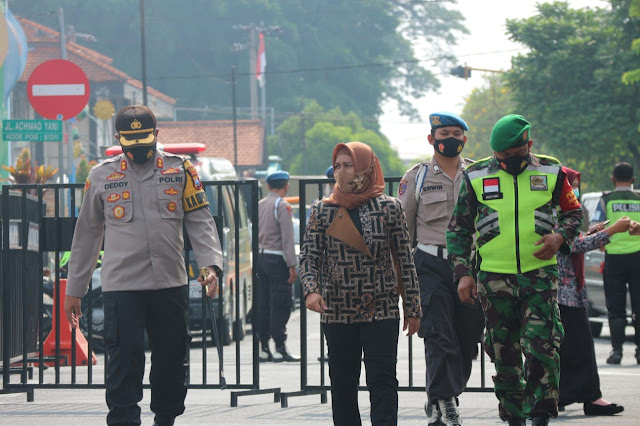 Mojokerto - Persiapan libur panjang pada akhir Oktober Pemerintah Kota Mojokerto bersama Polres Mojokerto Kota dan Kodim 0815 siap menggelar pengamanan. Pada Selasa (27/10) Wali kota Mojokerto Ika Puspitasari mempimpin apel gelar pasukan dalam rangka kesiapan pengamanan antisipasi libur panjang dan peringatan Maulid Nabi Muhammad SAW bertempat di Alun-alun Kota Mojokerto.  Dalam amanatnya Ning Ita mengapresiasi terselenggaranya kegiatan ini, sebagai bentuk upaya sinergitas dan kegotongroyongan seluruh jajaran Forkopimda, dalam rangka menjaga kondusifitas wilayah Kota Mojokerto, sekaligus mengantisipasi pengamanan terhadap libur panjang dan cuti bersama, serta peringatan maulid Nabi Muhammad tahun 2020.  Apel gelar pasukan diikuti oleh anggota TNI/Polri, petugas dari Dinas Perhubungan, tenaga kesehatan dari Dinas kesehatan Kota Mojokerto serta relawan. “Mulai hari Rabu sampai dengan Minggu (28 Oktober - 1 November 2020), sebanyak 240 peserta gabungan dari TNI, Polri, Pemerintah Kota Mojokerto yang terdiri dari Dinas Perhubungan, Satpol PP dan unsur tenaga kesehatan serta relawan. Kegiatan ini akan memberikan pengamanan dan pembatasan di 8 titik, serta bergerak secara dinamis,”ujar Ning Ita.  “Sejumlah 5.000 alat rapid test disiapkan oleh petugas yang bergerak secara dinamis di seluruh wilayah Kota Mojokerto bagi seluruh masyarakat yang dijaring secara masif, dan bagi warga luar kota yang akan masuk ke wilayah Kota Mojokerto atau menginap,” kata Ning Ita. Ia menambahkan bahwa Pemerintah Kota Mojokerto telah menyiapkan rusunawa untuk menjadi tempat karantina bagi warga Kota Mojokerto yang terbukti reaktif dari hasil rapid ketika operasi berlangsung. Sedangkan bagi warga dari luar Kota Mojokerto akan dikarantina di Balai Diklat sebelum dijemput oleh petugas dari daerah asal masing-masing.    Libur panjang yang bersamaan dengan peringatan Maulid Nabi Muhammad SAW menjadi perhatian khusus Ning Ita yang juga menjabat sebagai Ketua Gugus Tugas Percepatan Penanganan Covid-19 Kota Mojokerto. “Selain 8 titik operasi tercatat ada 15 titik yang akan melaksanakan kegiatan keagamaan dalam rangka peringatan Maulid Nabi Muhammad SAW, pada kegiatan tersebut telah dilakukan assesment pada seluruh panitia penyelenggara agar melakasanakan protokol secara ketat juga pembatasan terhadap peserta atau jamaah yang akan menyelenggarakan peringatan Maulid Nabi,”lanjut Ning Ita. Ia menambahkan bahwa Pemerintah Kota Mojokerto telah menyiapkan Sebanyak 20 ribu masker yang akan dibagikan kepada jamaah dan masyarakat yang ada di wilayah Kota Mojokerto.  Kegiatan ini dilaksanakan sebagai tindak lanjut dari surat edaran Mendagri dalam rangka antisipasi pengamanan libur panjang dan cuti bersama bisa dilakukan dengan lancar  dan petugas yang tergabung dalam operasi senantiasa diberikan kesehatan karena keberhasilan operasi terletak pada kesehatan, kemampuan serta kekuatan peserta gabungan guna mengendalikan penyebaran covid-19 di Kota Mojokerto.   Hadir pada apel ini, Kapolresta Deddy Supriadi, Danramil Prajurit Kulon Kapten Budiono mewakili Dandim 0815 Mojokerto, Komandan Garnisun  Kapten Ahmad Budiarto mewakili Dandenpom Mojokerto, Kepala Dinas Perhubungan, Kepala Dinas Kesehatan dan Kepala Satpol PP Kota Mojokerto. (Jayak)