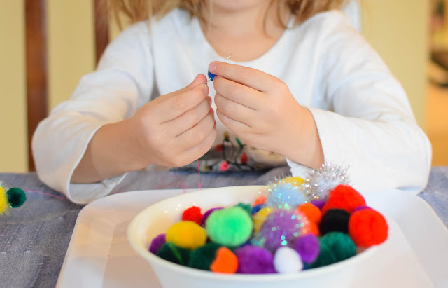 Rainbow Pompom Necklace Craft- fun activity for kids for spring, St. Patrick's Day, or a weather theme. Great for developing fine motor skills!
