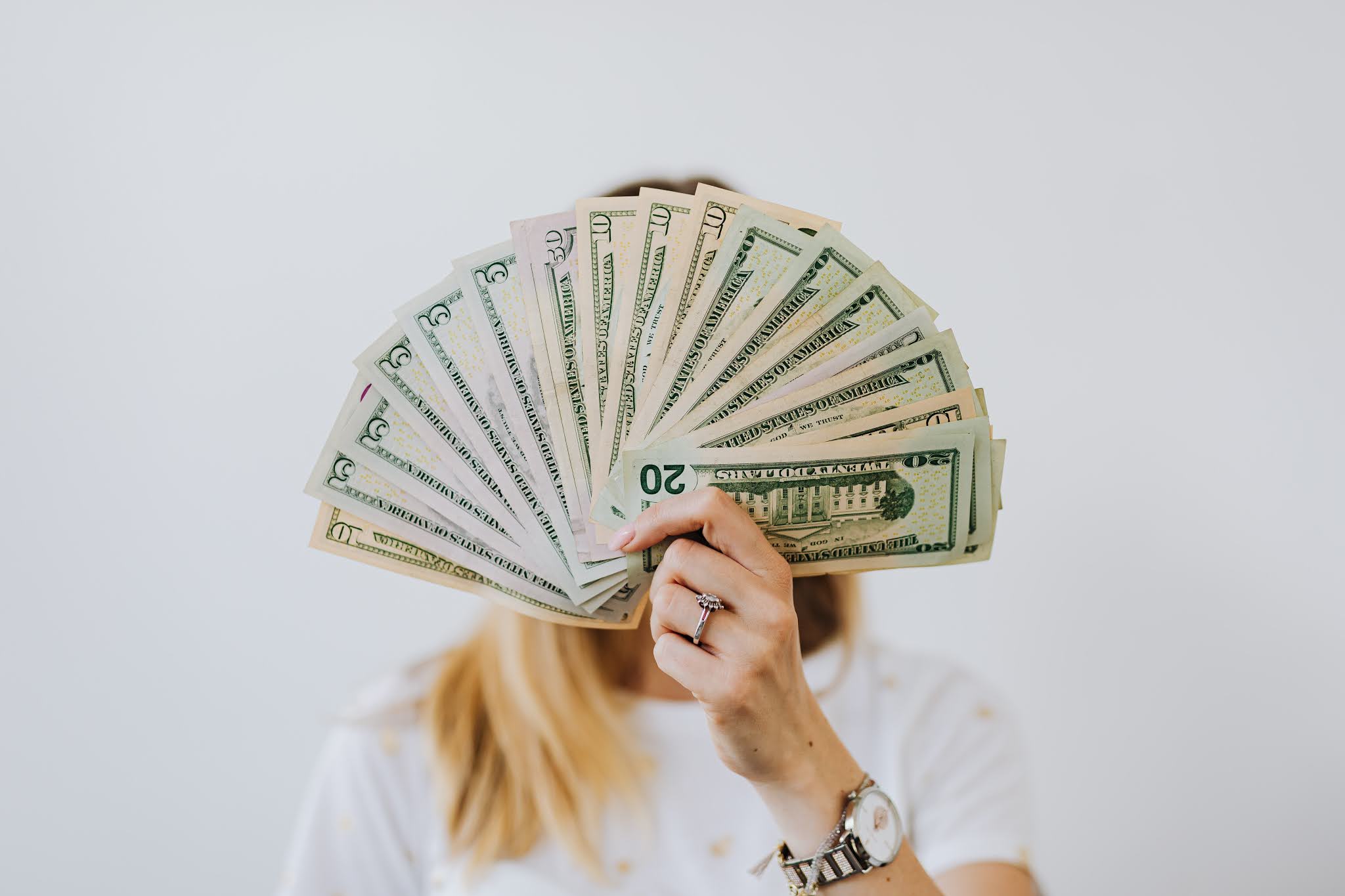 girl holding money in her hand