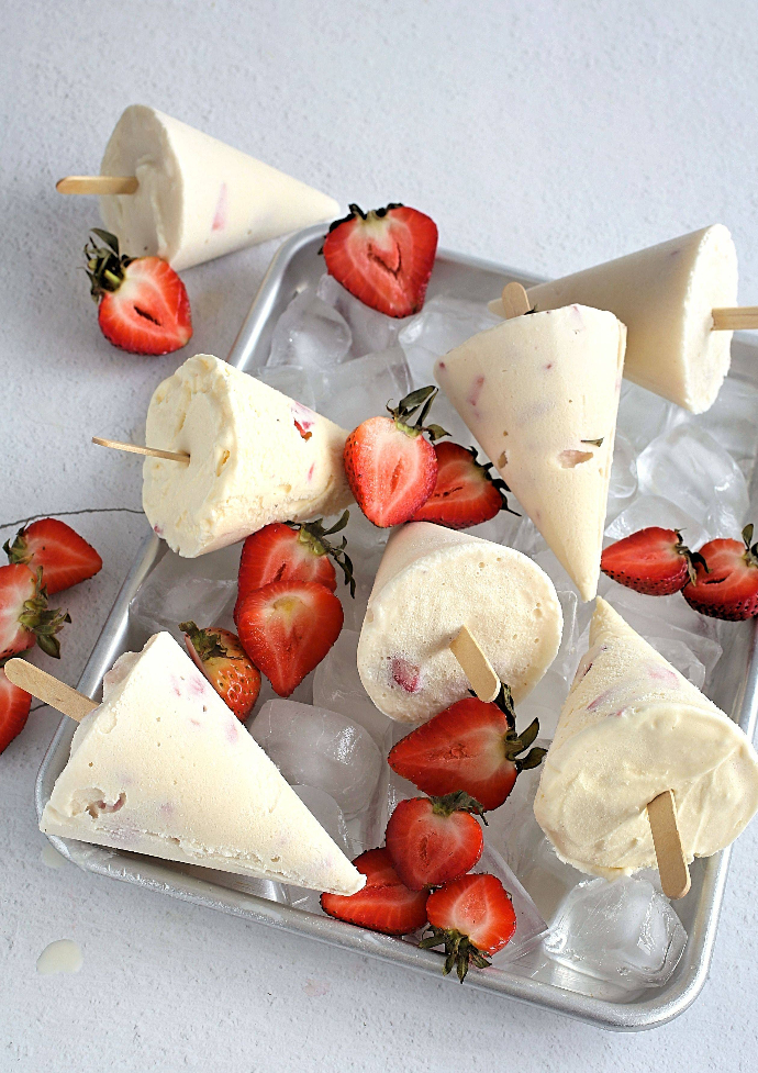Strawberries-and-Cream-Popsicles-1 Recipe for sweet and tangy vanilla ice cream popsicles swirled with fresh strawberries.