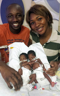 ENS Kiendrebeogo, his wife, and twin newborn girls. [Photo credit: Courtesy of ENS Kiendrebeogo]