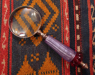 magnifying glass on aztec pattern fabric