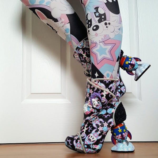 wearing galaxy themed tights with cat and dog ankle boots with rocket heel