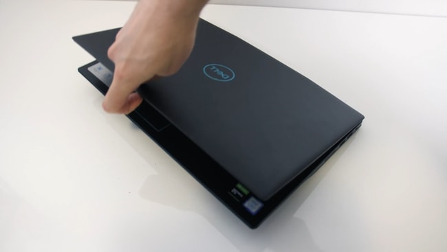 Trying to open the Dell G3 3500 with a finger to test the weight distribution across the hinge.