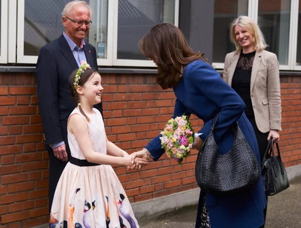 Crown Princess Mary wearing a great blue coat, a white blouse and printed pants. visited the Red Cross with the Mary Foundation