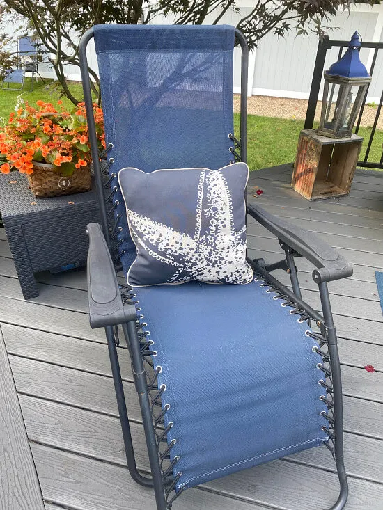 Blue sling deck chair with outdoor pillow