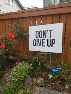 sign says don't give up