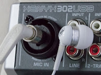 [Image: Sennheiser earplugs connected to the microphone preamp input of a Xenyx 302 USB audio interface.]