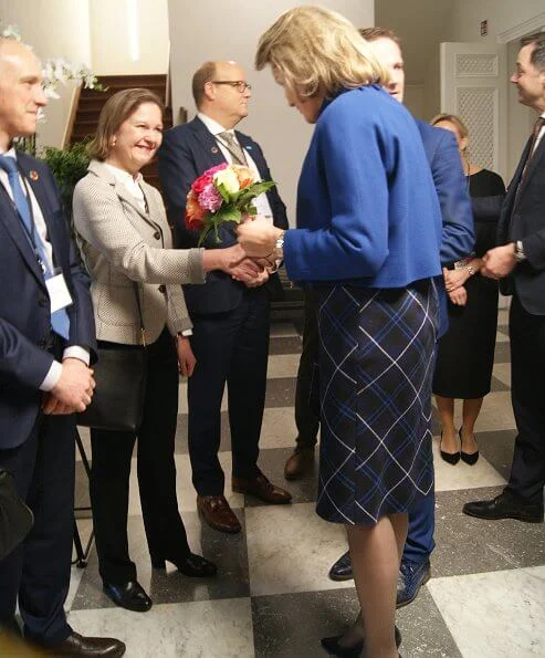 Queen Mathilde wore a new Natan dress and the queen wore a new blu jacket by Natan. United Nations Sustainable Development Goals