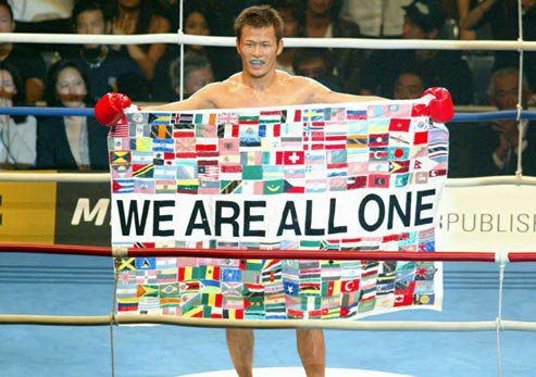 Genko Sudo with a flag - We Are All One
