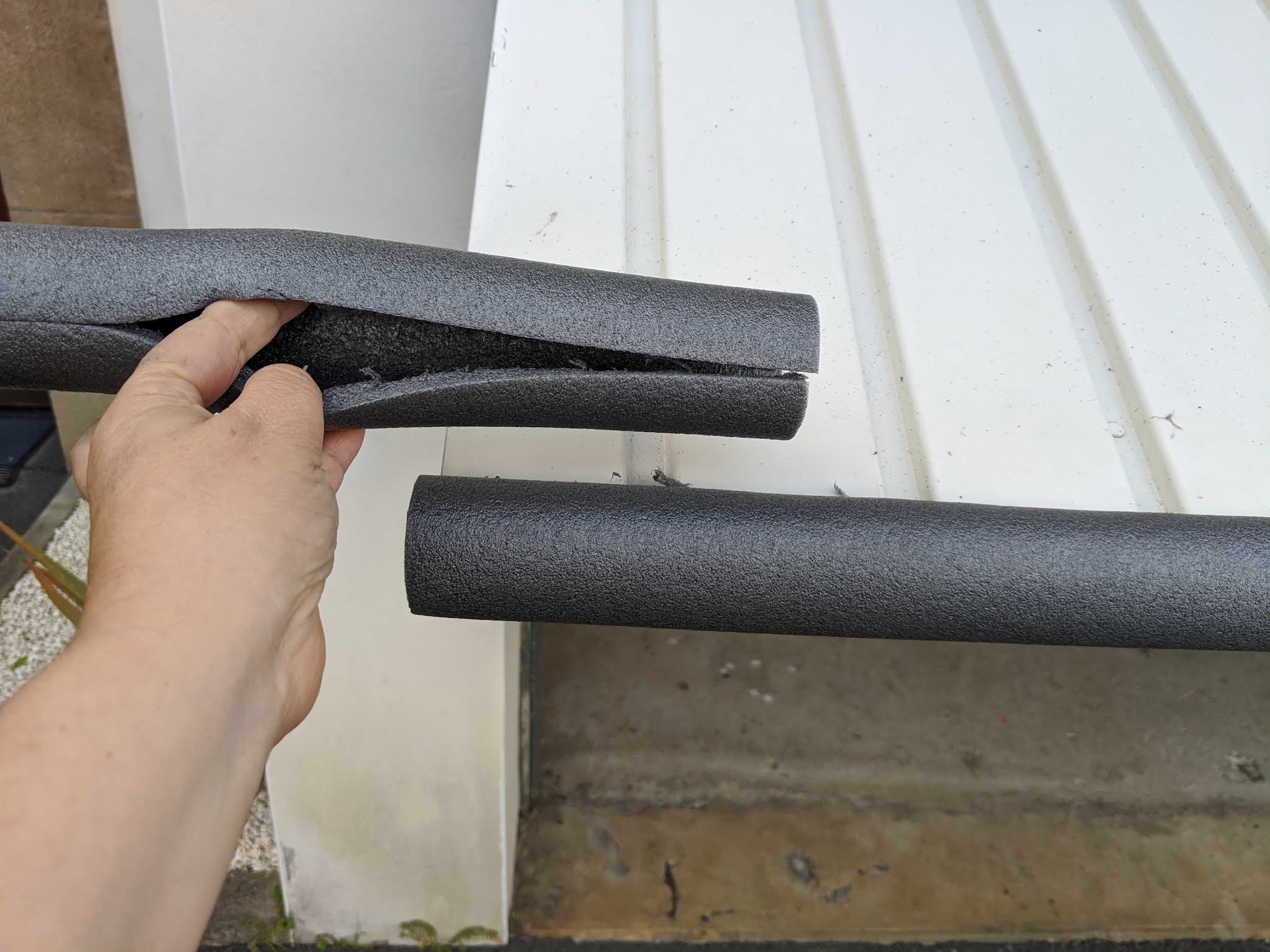 Insulate garage door with pipe foam