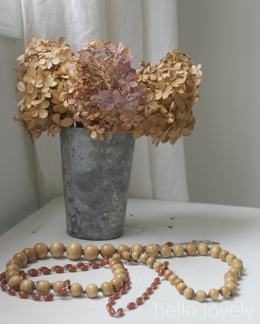 Beautiful dried hydrangea in zinc vase with wood beads by Hello Lovely Studio
