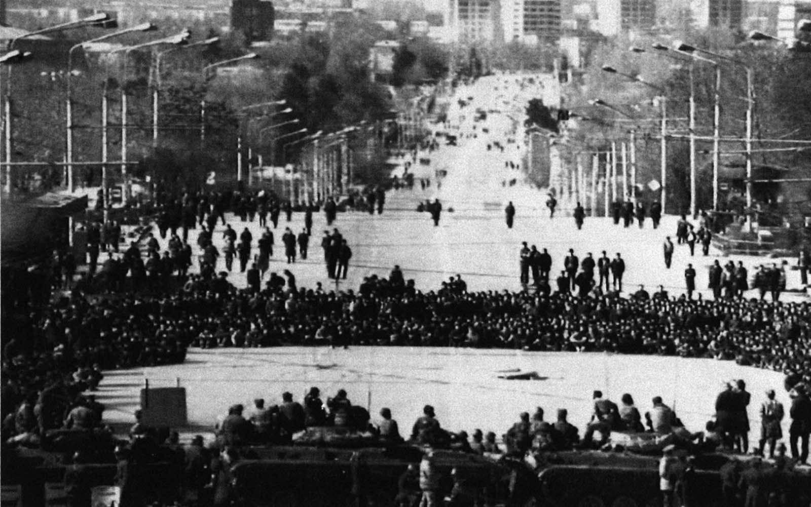 Residents face a cordon of Soviet Interior Ministry troops in front of the local Communist Party Headquarters in the Tajikistan capital of Dushanbe, on February 15, 1990. Soviet authorities declared a state of emergency in the city, following ethnic rioting.