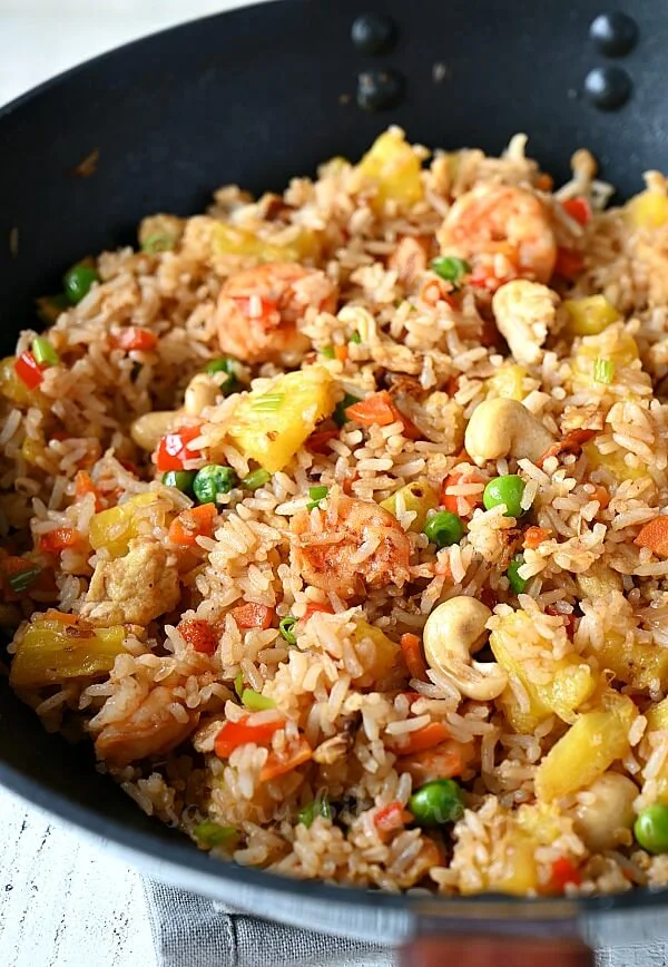 thai pineapple fried rice in a wok with shrimp,eggs and cashews