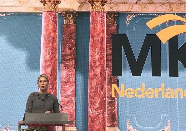 Queen Maxima gave an opening speech at the MKB Nederland congress in The Hague. Queen Maxima wore Sequin midi skirt and grey wool top