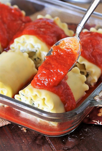 Spooning Sauce Over Spinach Lasagna Roll-Ups Image