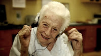 old lady smiling listing to music