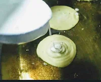 Pouring batter into ghee for frying Malpua