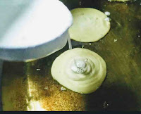 Pouring batter into ghee for frying Malpua