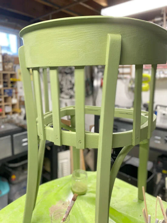painted green chair up on a table