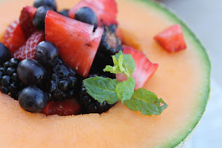 berries in melon with mint