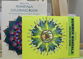 this is the image of two mandala coloring books, one is beige with 40 original drawings and the second is yellow with a fish mandala on its cover