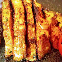 Frying pomfret fish pieces on a pan or tawa for pomfret fry recipe