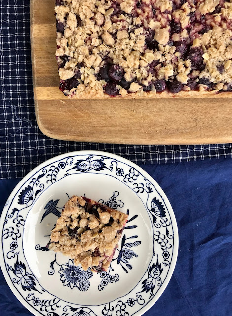 Serving plate with a blueberry oatmeal crisp bar.